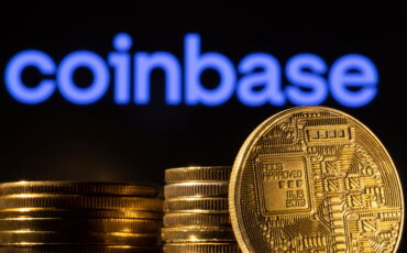 A representation of the cryptocurrency is seen in front of Coinbase logo in this illustration taken, March 4, 2022. REUTERS/Dado Ruvic/Illustration